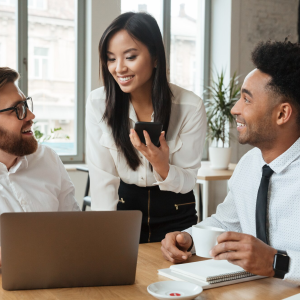 Staff members smiling and discussing business strategies in a bright office setting.